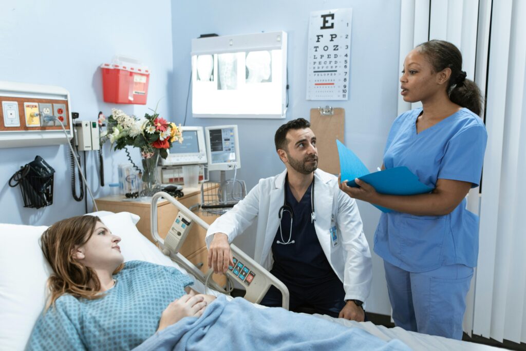 nurse discussing patient's treatment in a hospital room.